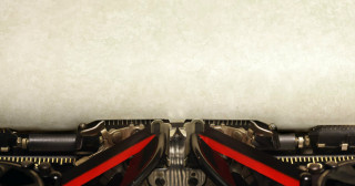 Old vintage typewriter with blank paper